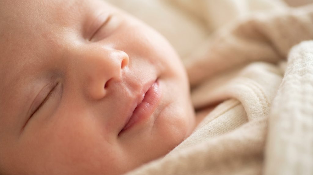 Extreme close up of a newborn 202605061601 2 - Is it normal if my 1-month-old doesn't smile yet? Honest answers for the parents who are already Googling at midnight.